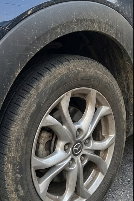 Mazda CX-3 wheel caked in mud and brake dust before detail