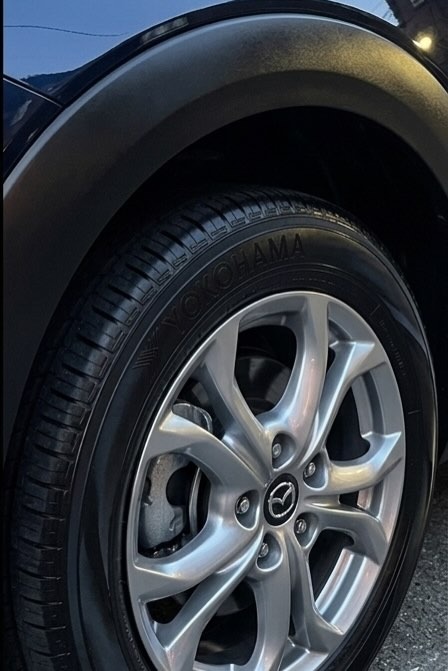 Same Mazda CX-3 wheel after detail, cleaned to a bright shine